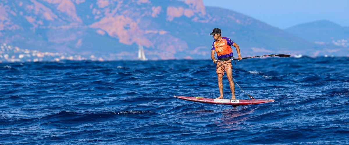 Downwind foil racing at Les Ailes de Saint-Tropez on an AXIS + FRANK board, the Esterel behind